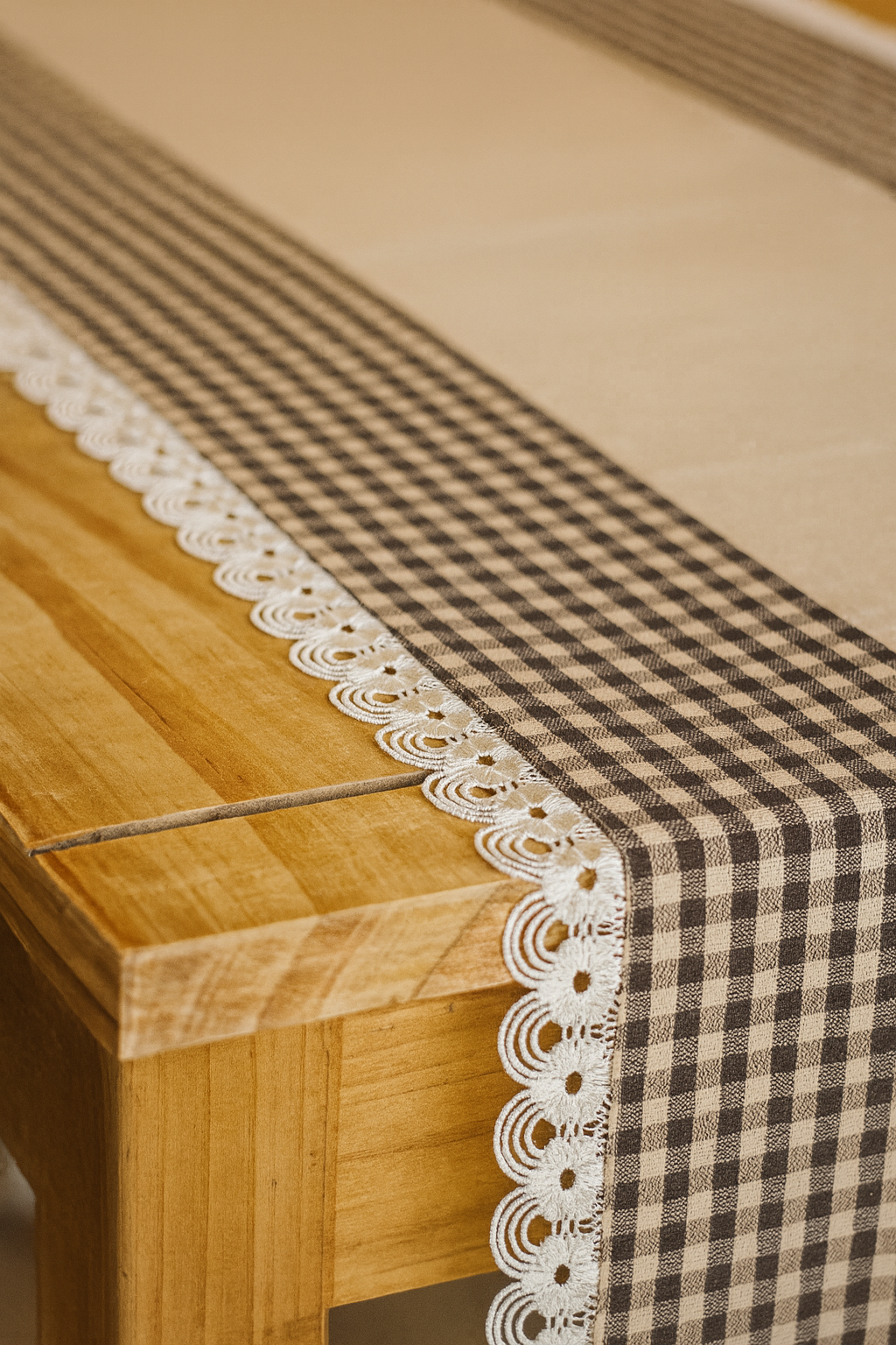 Artisan-made beige and brown check table runner on wooden dining table