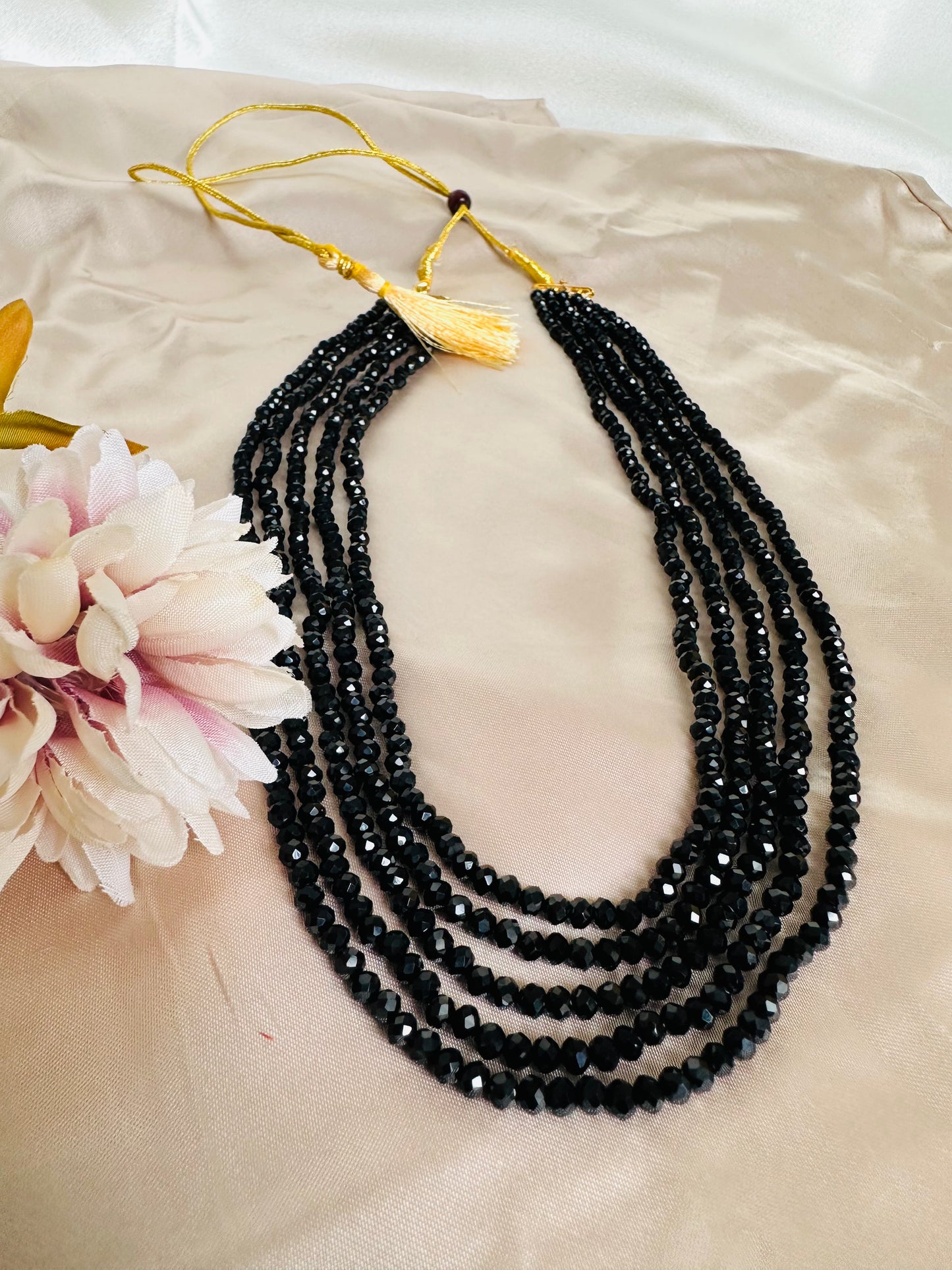 Black coloured 5-Layer Crystal Beaded Handmade Necklace with adjustable string at the back.