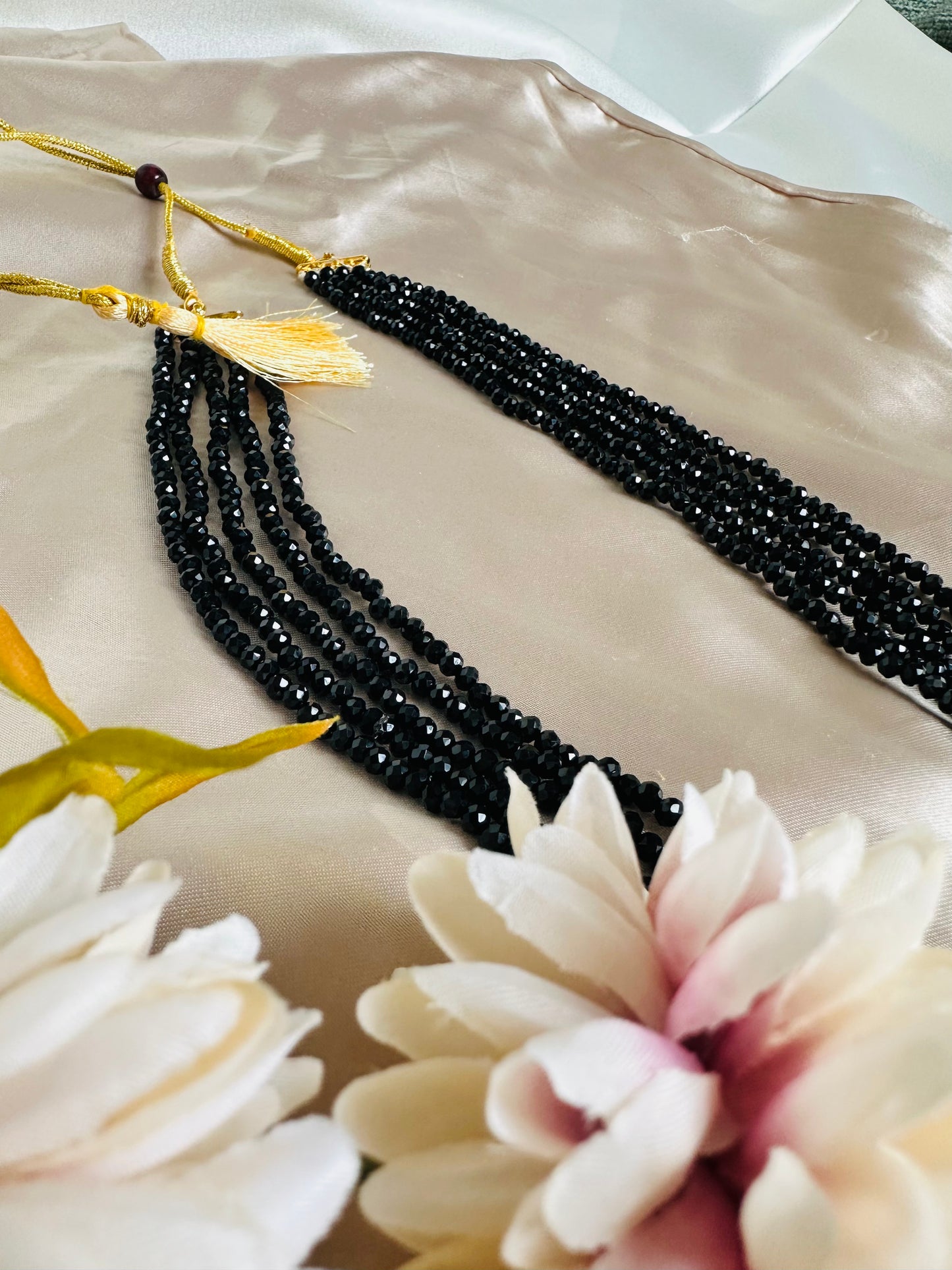 Black coloured 5-Layer Crystal Beaded Handmade Necklace with length adjustable string at the back.
