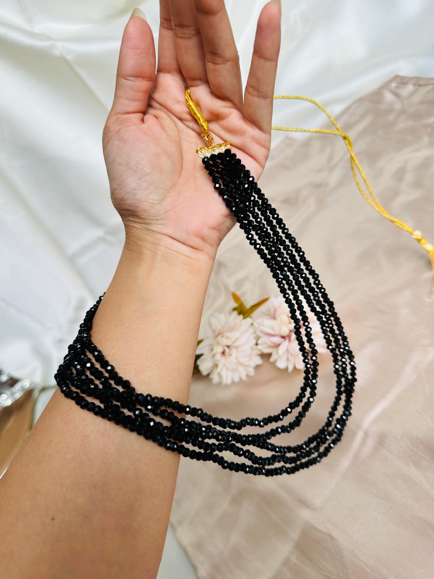 Black coloured 5-Layer Crystal Beaded Handmade Necklace with length adjustable string at the back.