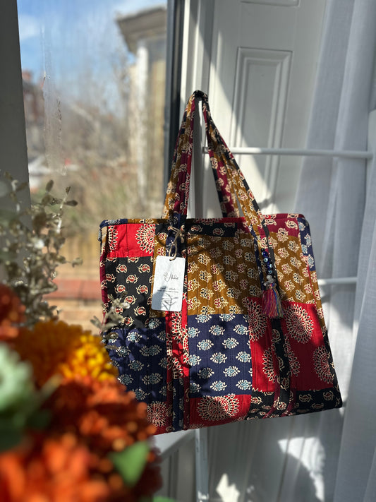 Handmade patchwork tote bag with zipper closure and Evil Eye tassels
