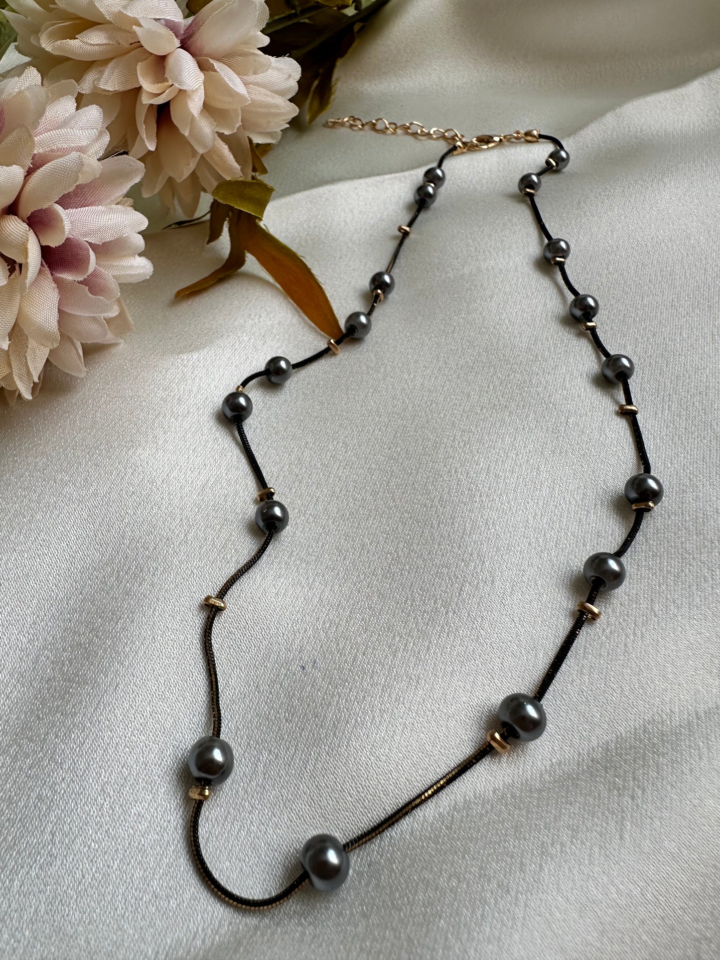 Black and gold coloured multi shaded chain Necklace with Grey coloured Pearl (Faux)  placed at equidistance. Elegant Statement Jewellery with adjustable hook and chain.