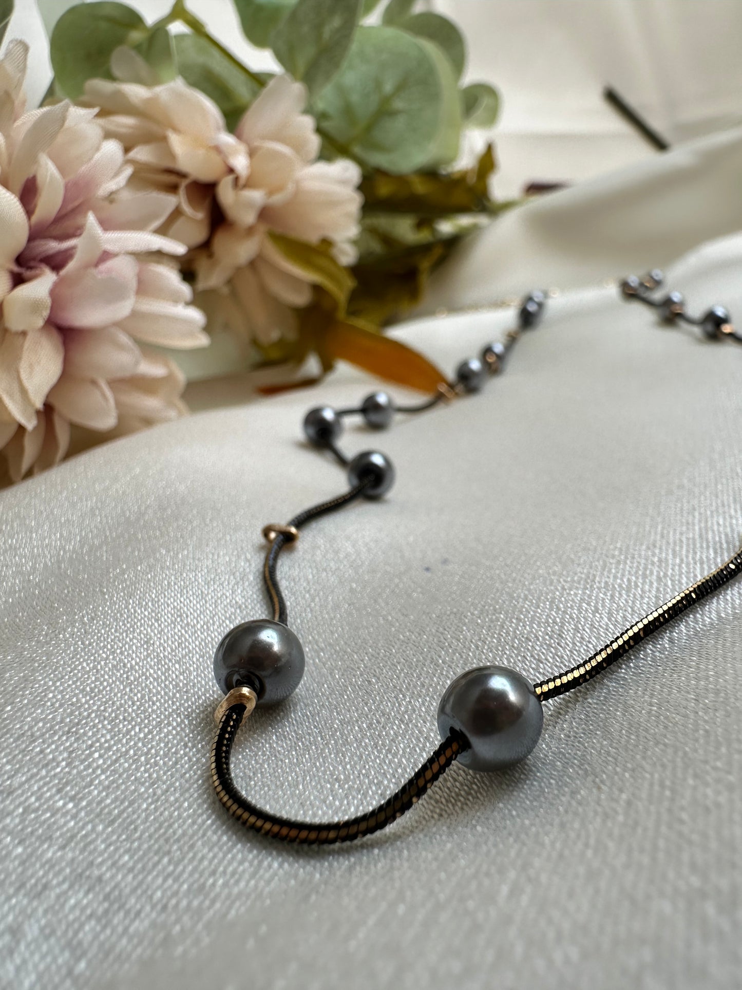 Black and gold coloured multi shaded chain Necklace with Grey coloured Pearl (Faux)  placed at equidistance. Elegant Statement Jewellery with adjustable hook and chain.