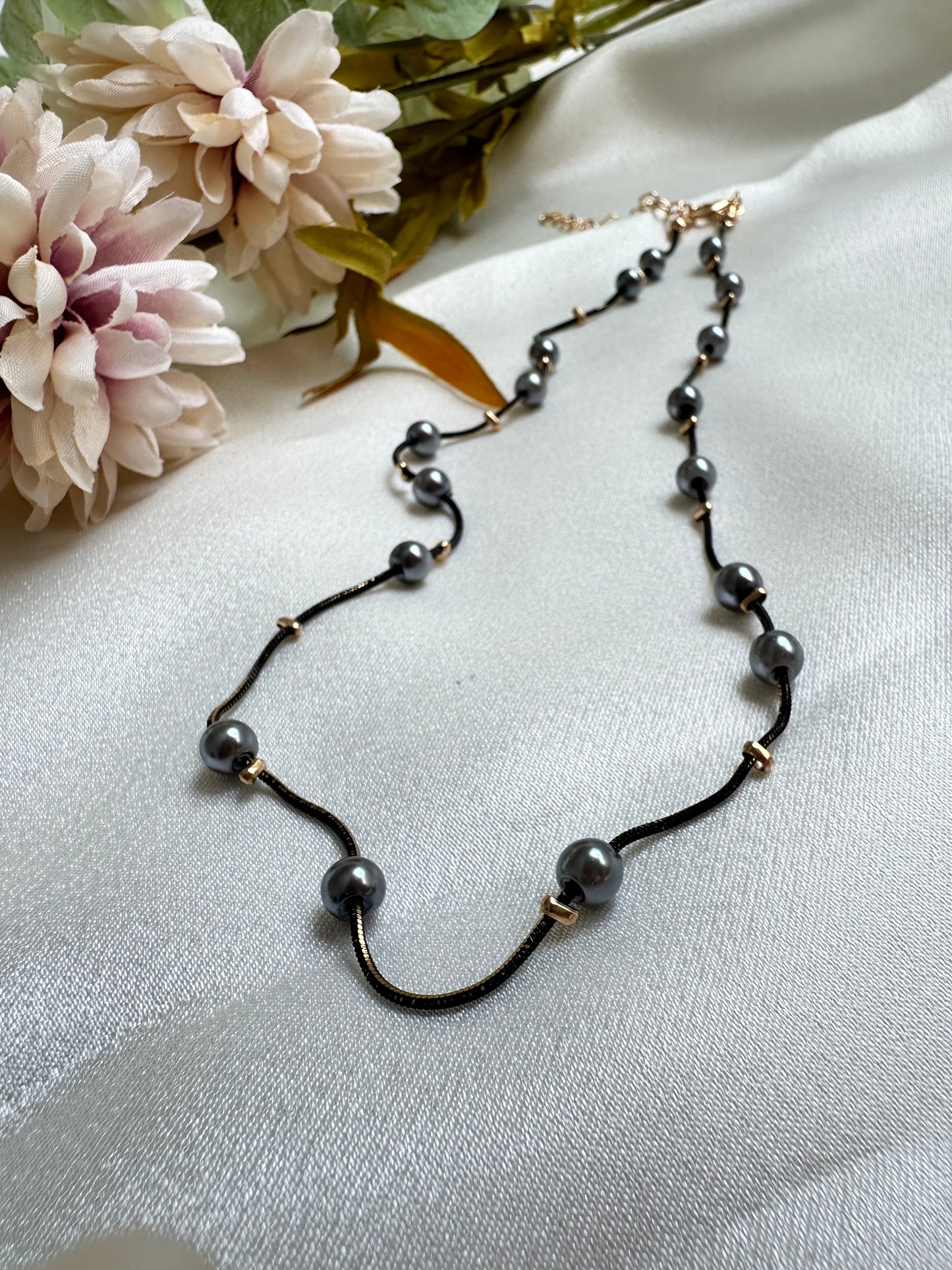 Black and gold coloured multi shaded chain Necklace with Grey coloured Pearl (Faux)  placed at equidistance. Elegant Statement Jewellery with adjustable hook and chain.