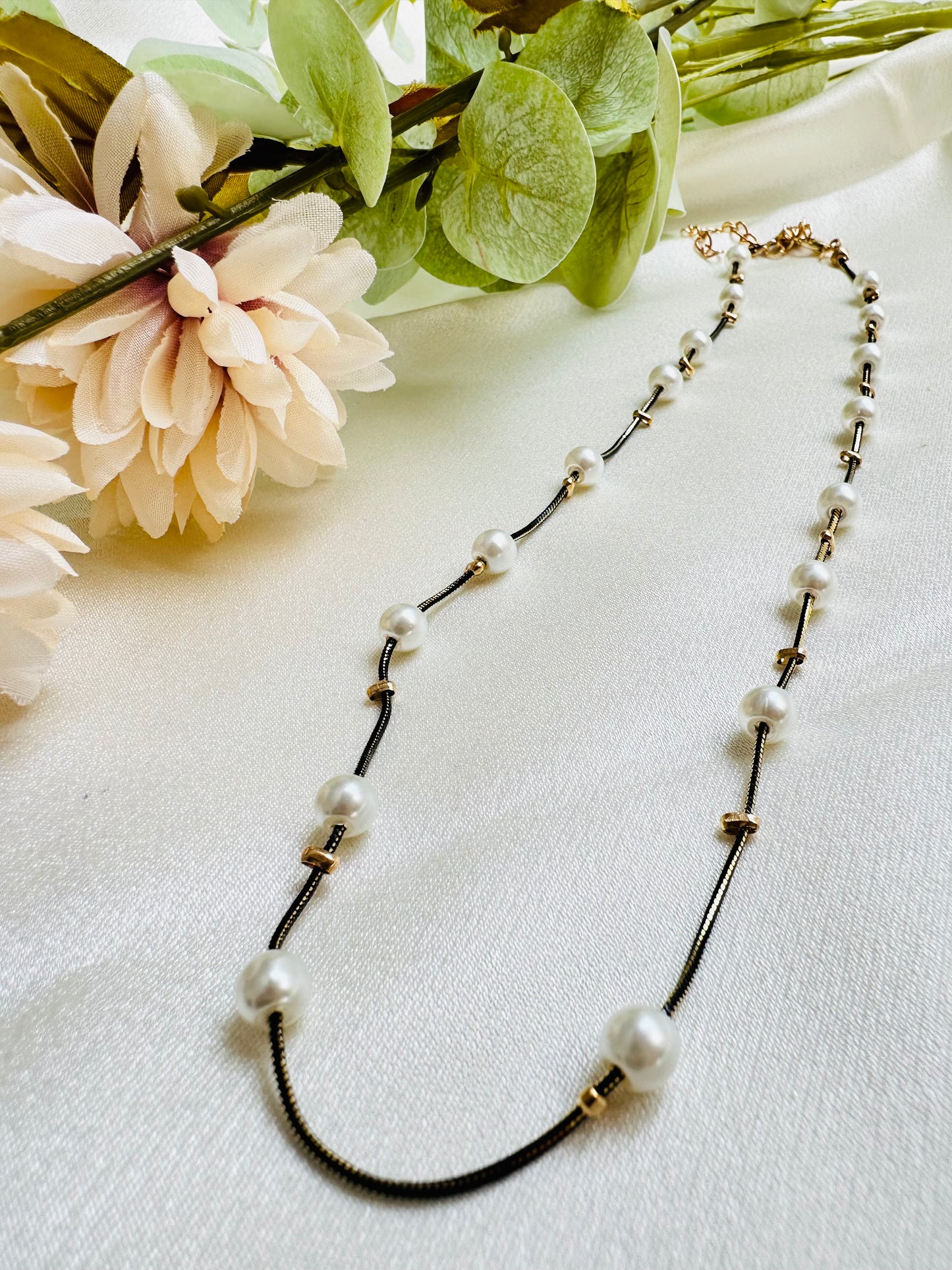 Black and gold coloured multi shaded chain Necklace with White coloured Pearl (Faux)  placed at equidistance. Elegant Statement Jewellery with adjustable hook and chain.