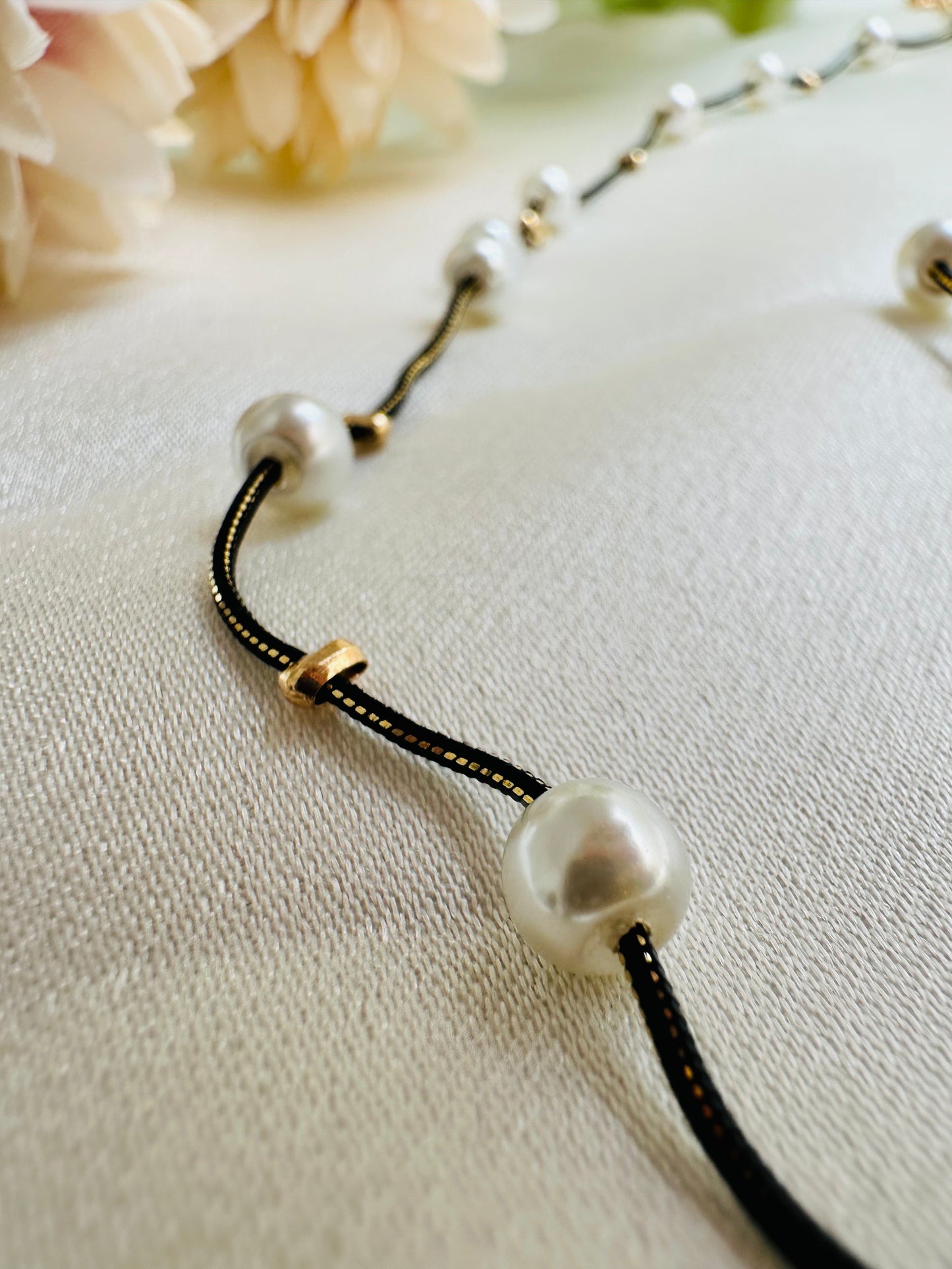 Black and gold coloured multi shaded chain Necklace with White coloured Pearl (Faux)  placed at equidistance. Elegant Statement Jewellery with adjustable hook and chain.