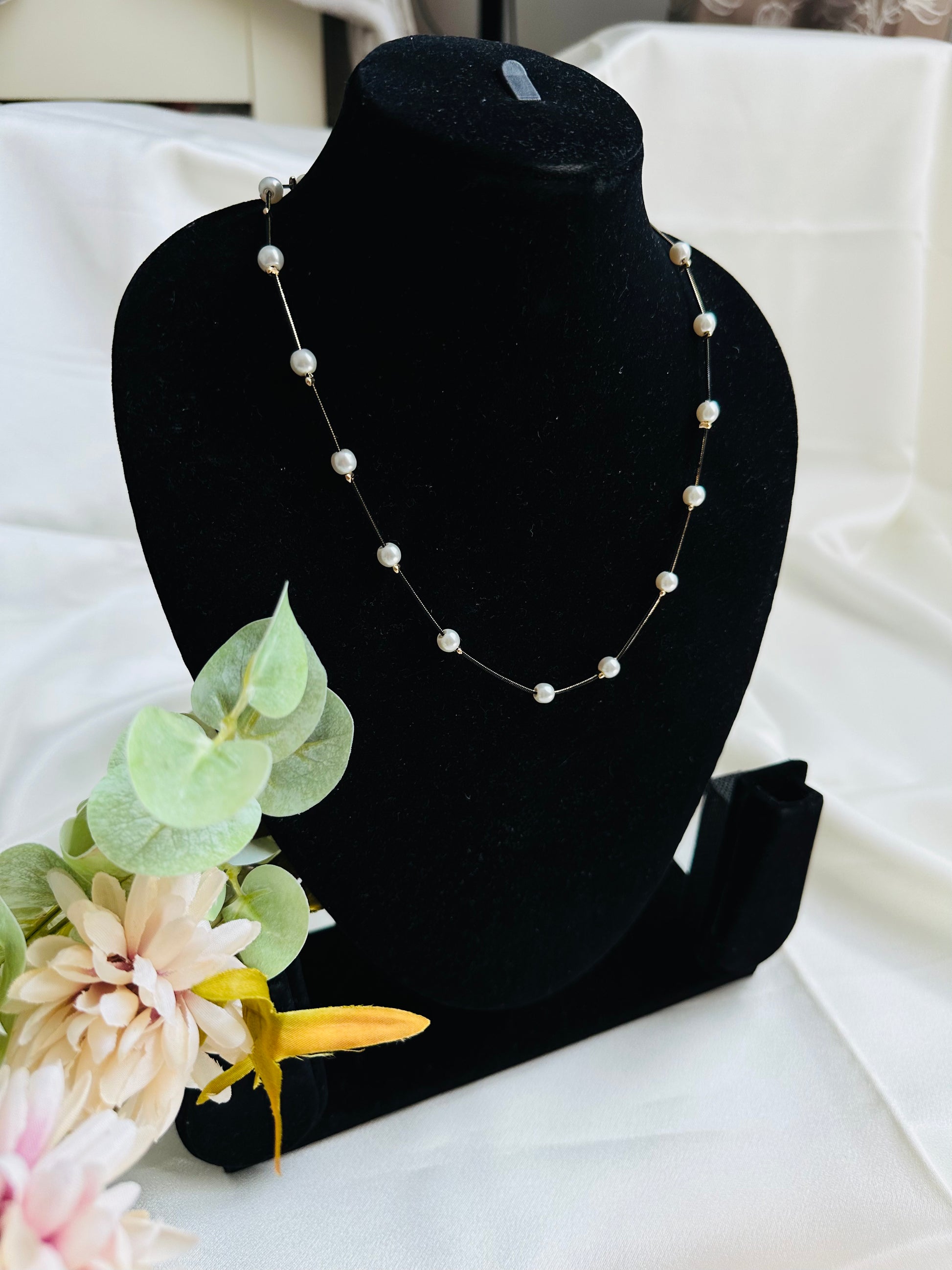 Black and gold coloured multi shaded chain Necklace with White coloured Pearl (Faux)  placed at equidistance. Elegant Statement Jewellery with adjustable hook and chain.