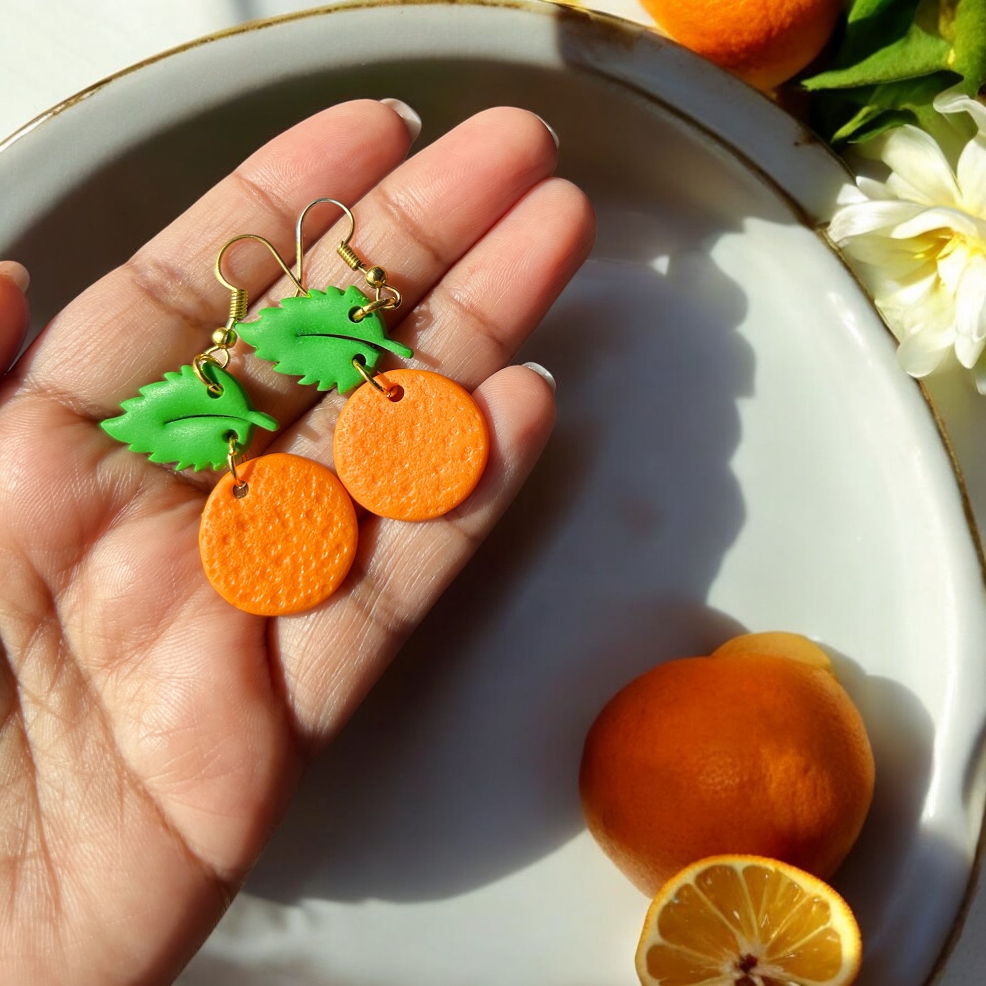 Bright citrus-themed earrings made from polymer clay
