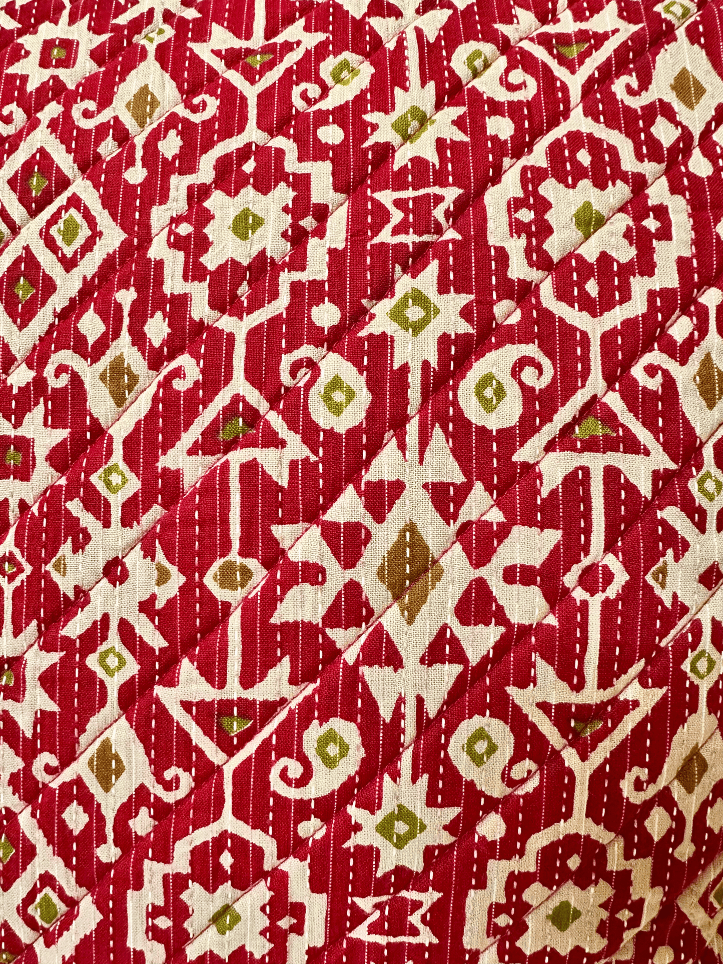 Red fabric  of a cushion cover with a geometric pattern
