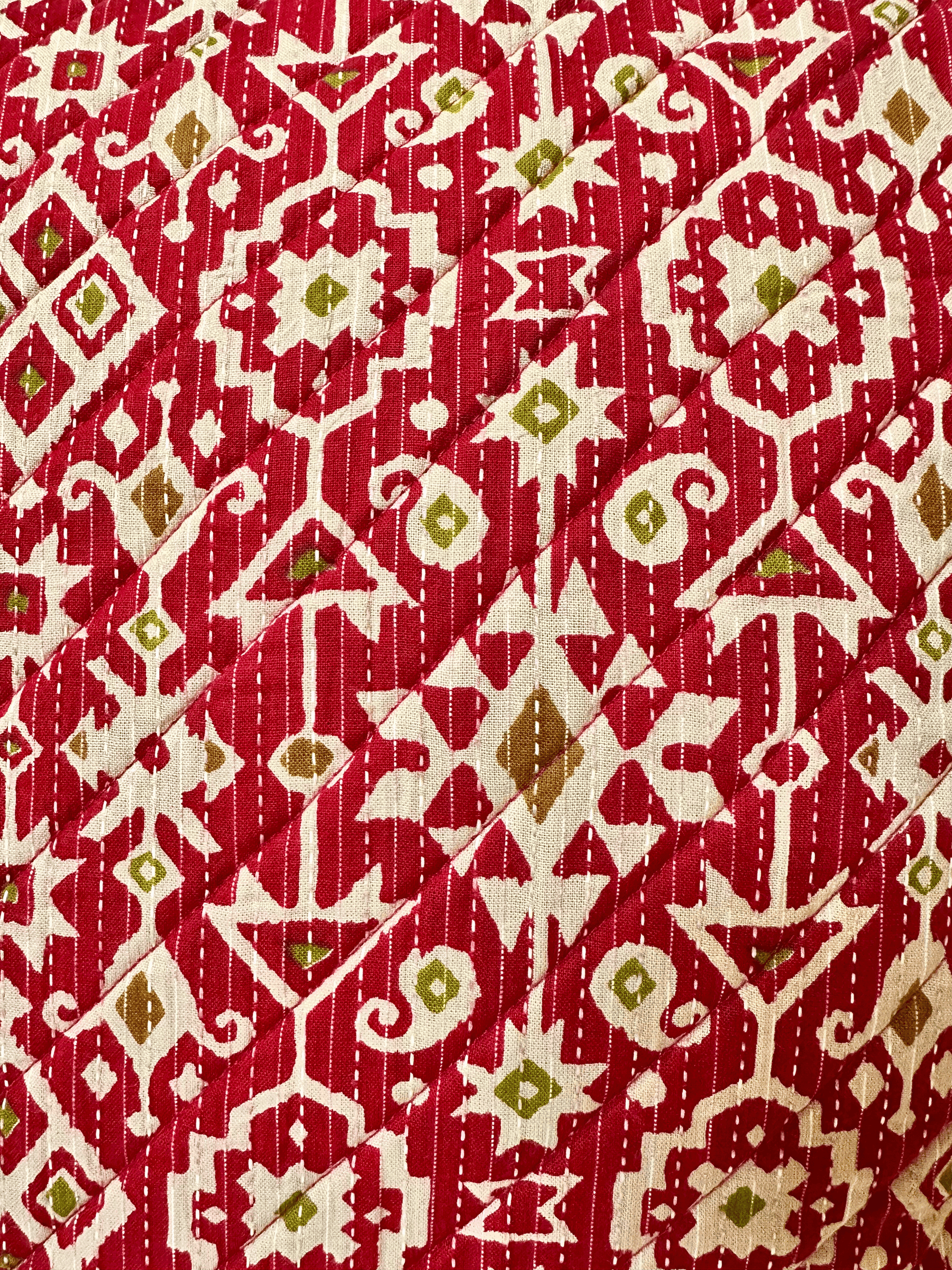 Red fabric  of a cushion cover with a geometric pattern