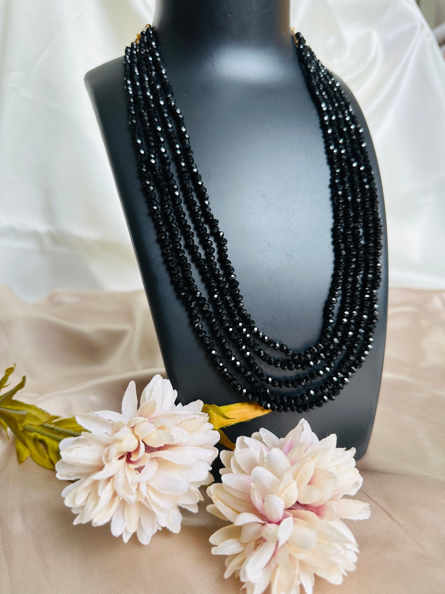 Black coloured 5-Layer Crystal Beaded Handmade Necklace with adjustable string at the back, displayed on a neck. 