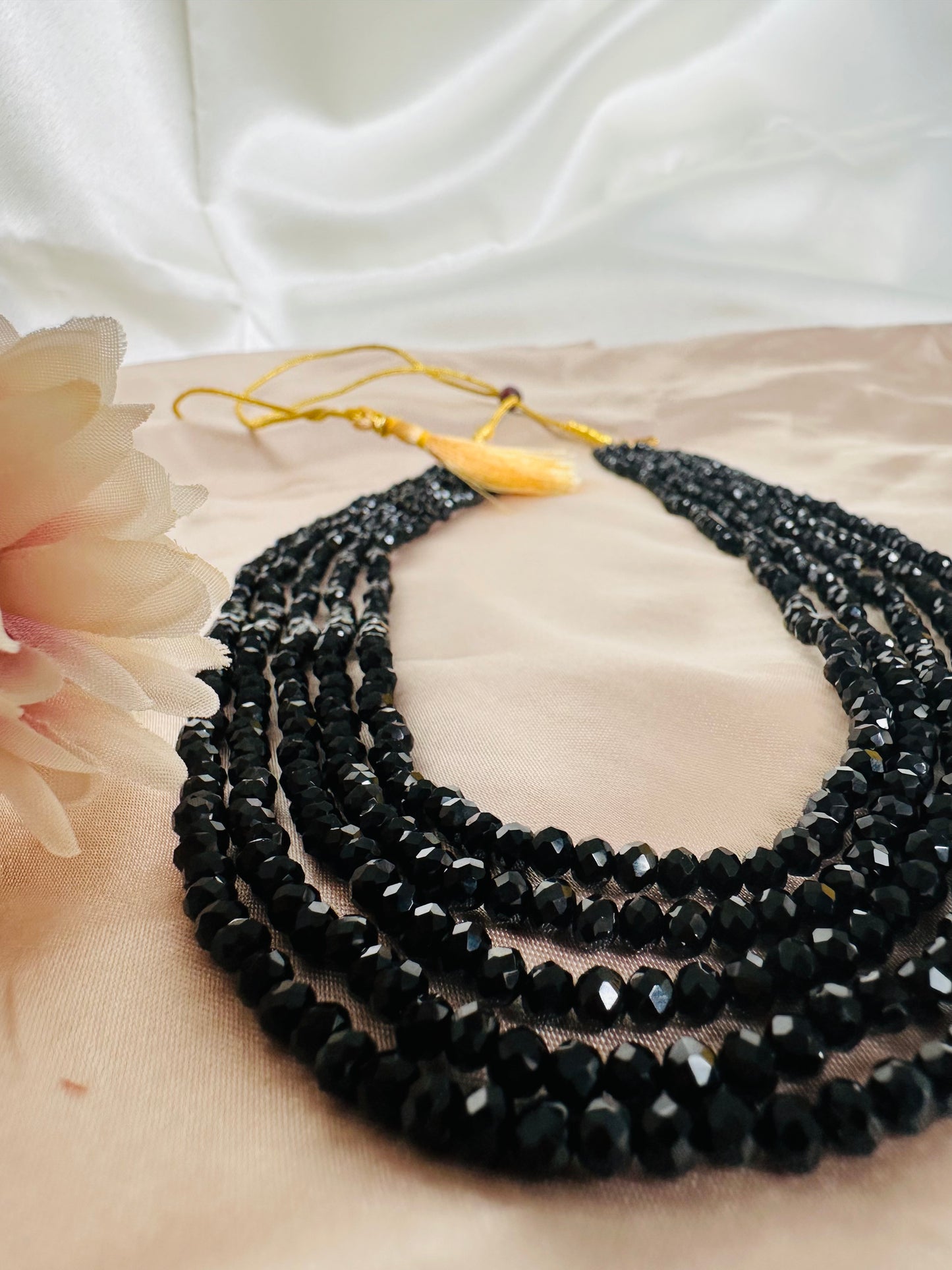 Black coloured 5-Layer Crystal Beaded Handmade Necklace with length adjustable string at the back. 