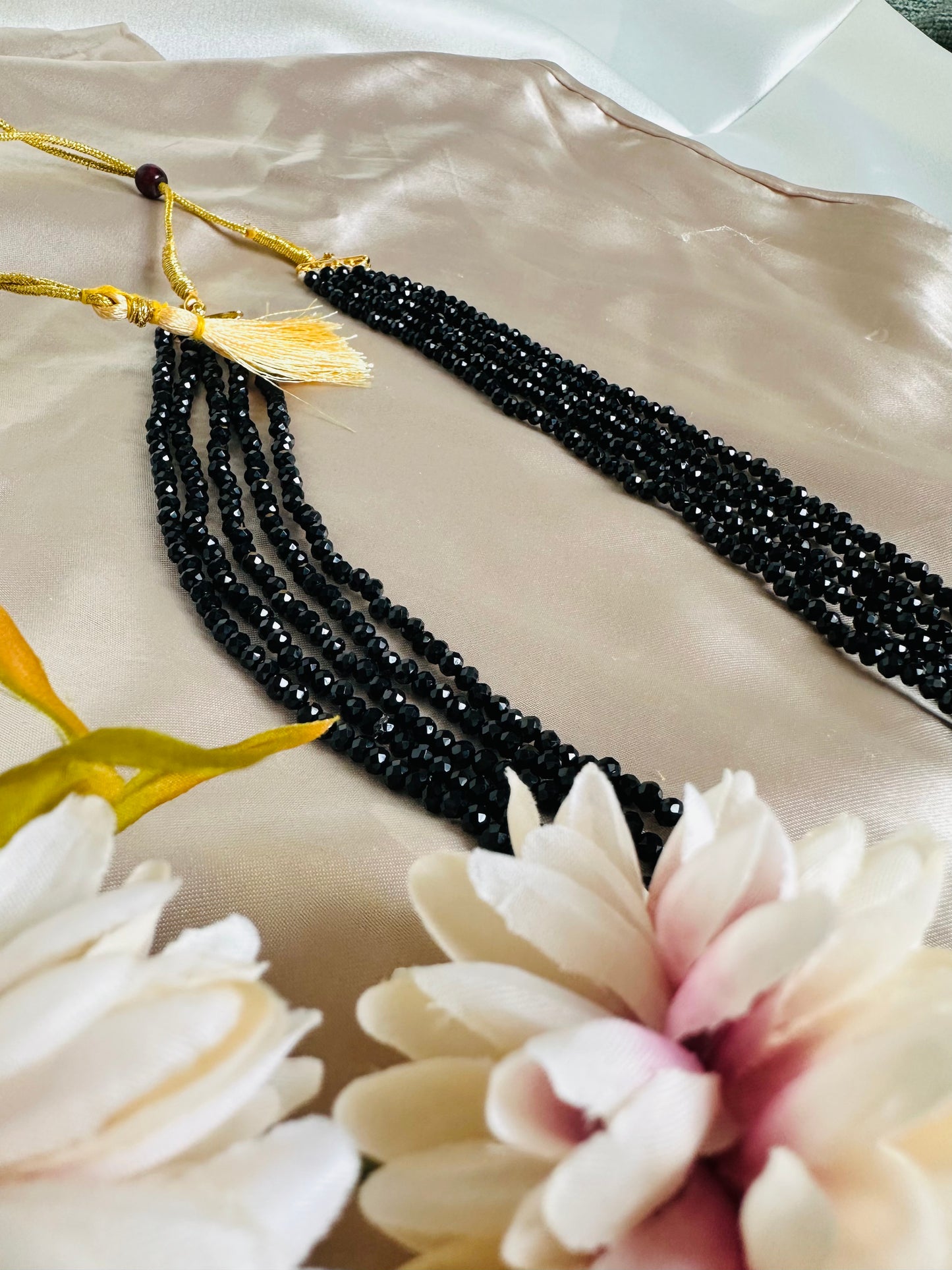 Black coloured 5-Layer Crystal Beaded Handmade Necklace with length adjustable string at the back. 