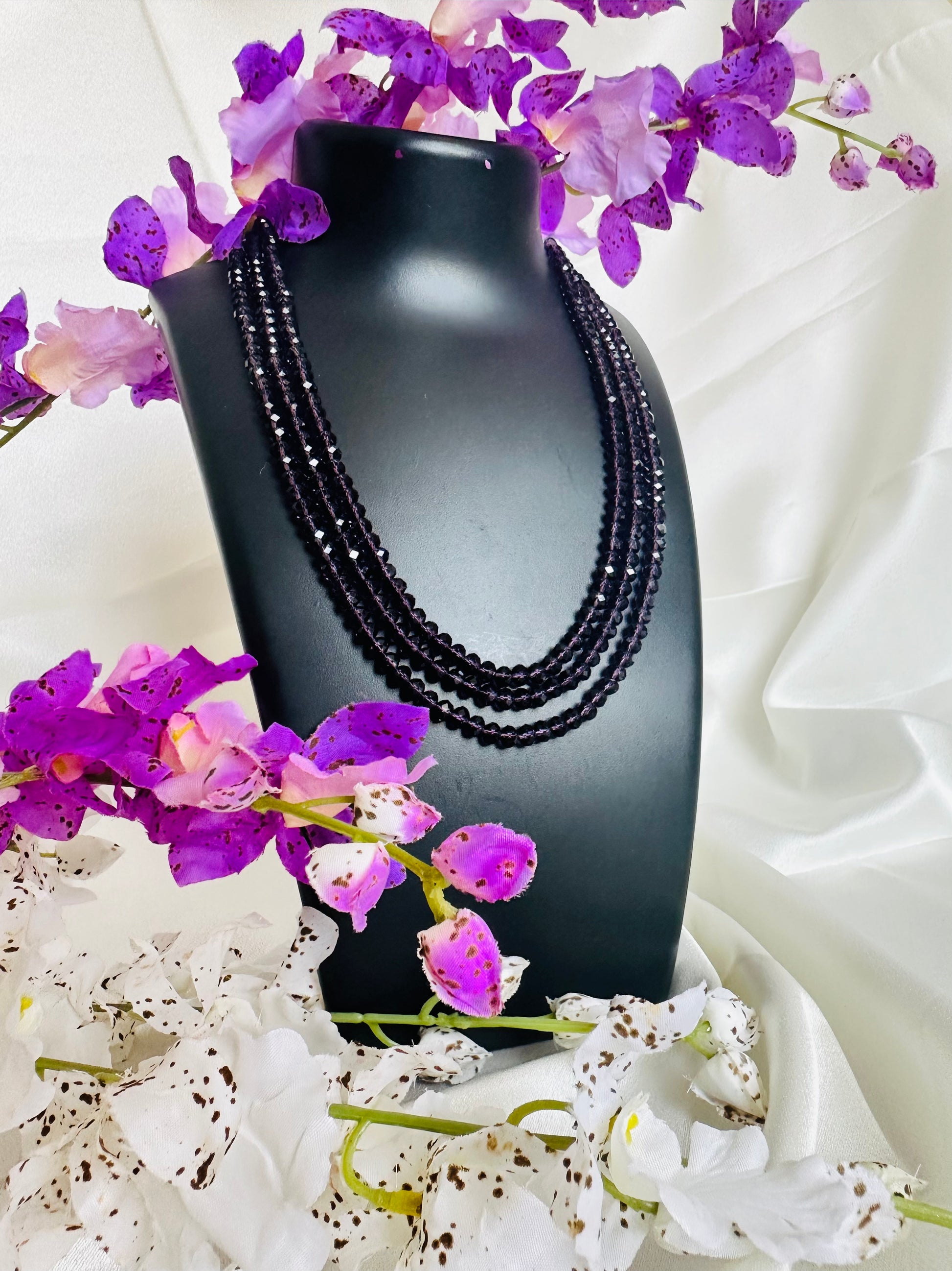 Aubergine coloured 3 Layered Crystal Beaded handmade Necklace on a display neck