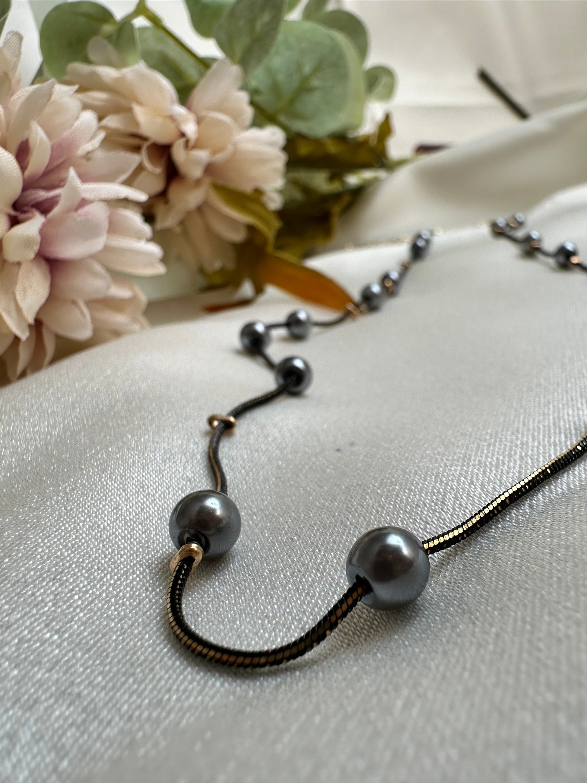 Black and gold coloured multi shaded chain Necklace with Grey coloured Pearl (Faux)  placed at equidistance. Elegant Statement Jewellery with adjustable hook and chain. 