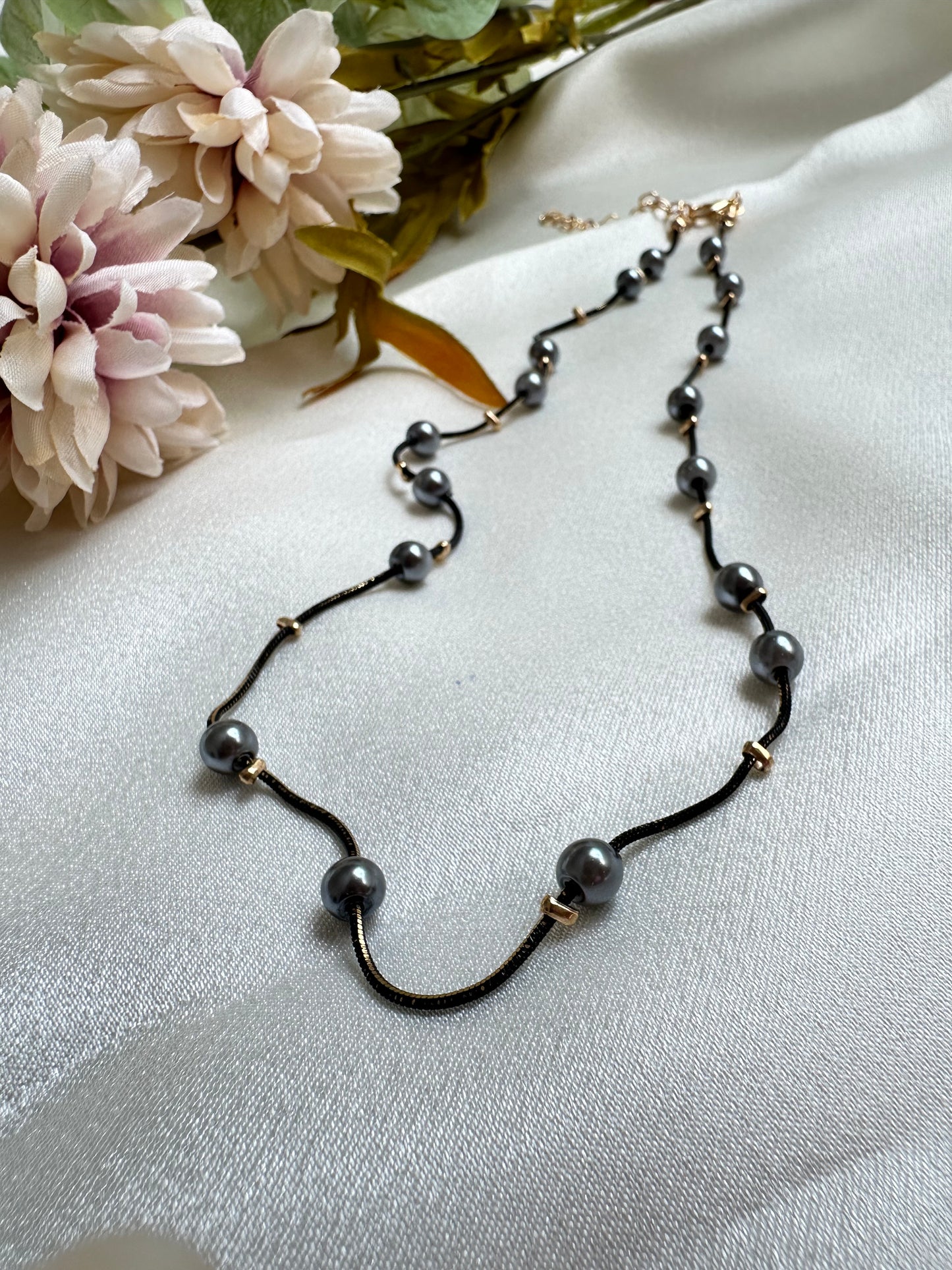 Black and gold coloured multi shaded chain Necklace with Grey coloured Pearl (Faux)  placed at equidistance. Elegant Statement Jewellery with adjustable hook and chain. 