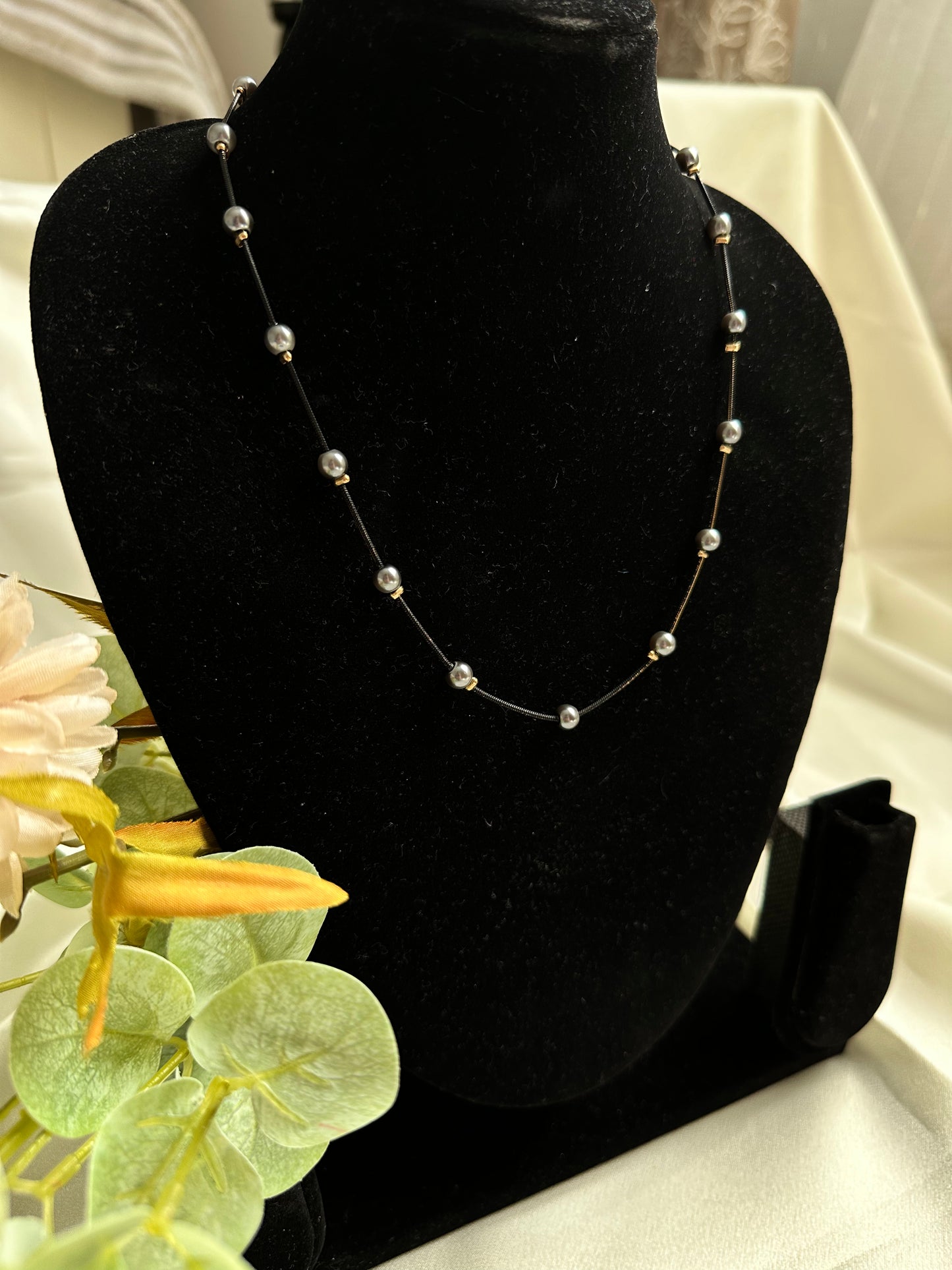 Black and gold coloured multi shaded chain Necklace with Grey coloured Pearl (Faux)  placed at equidistance. Elegant Statement Jewellery with adjustable hook and chain. 